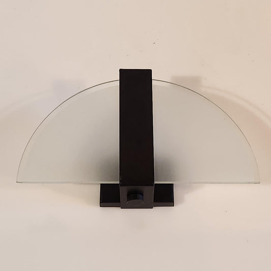 Wall lamp with a half circle frosted glass and black metal stripe in the middle. 
Width 29 cm. Height 16 cm. - FRONT -