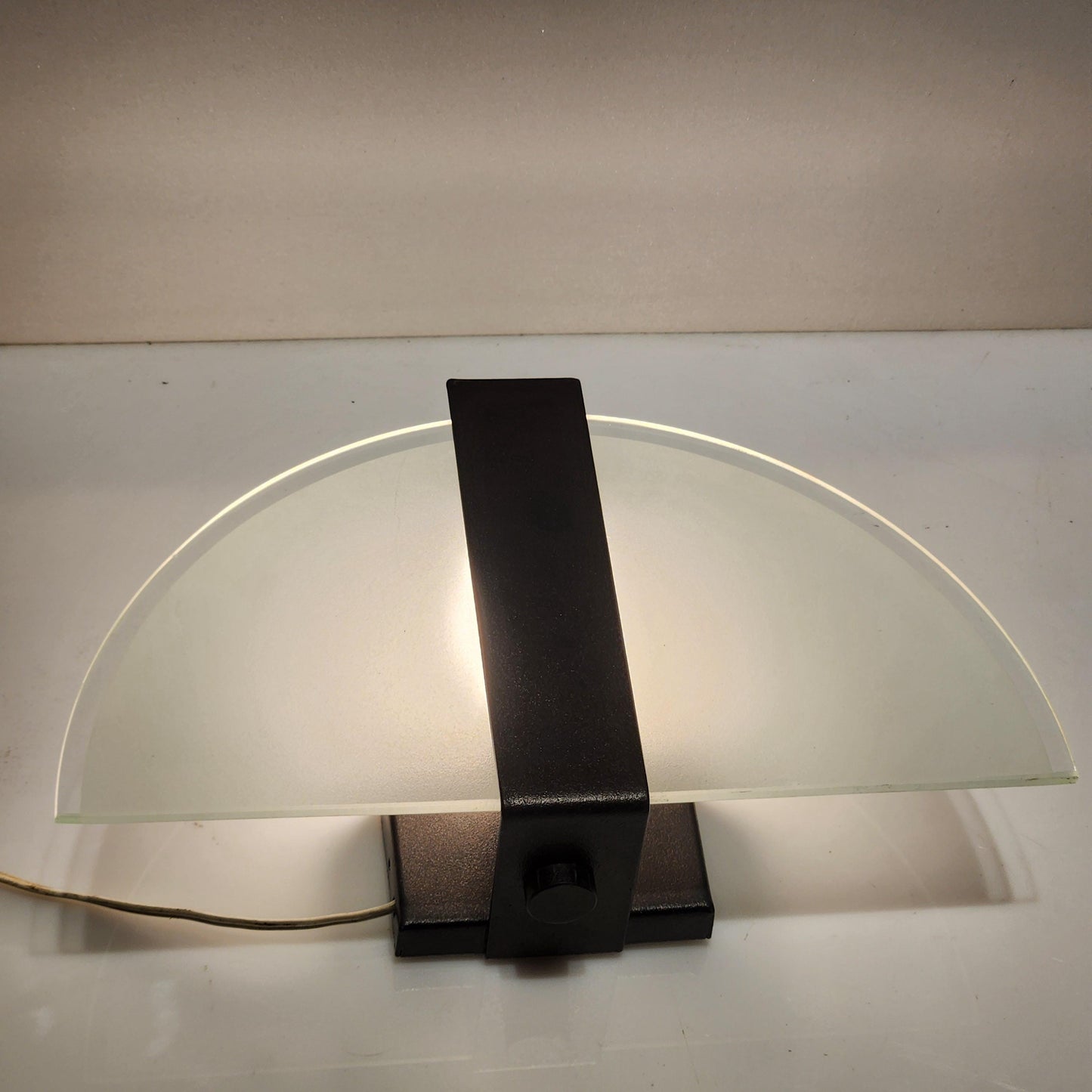 Wall lamp with a half circle frosted glass and black metal stripe in the middle. 
Width 29 cm. Height 16 cm. - TOP -