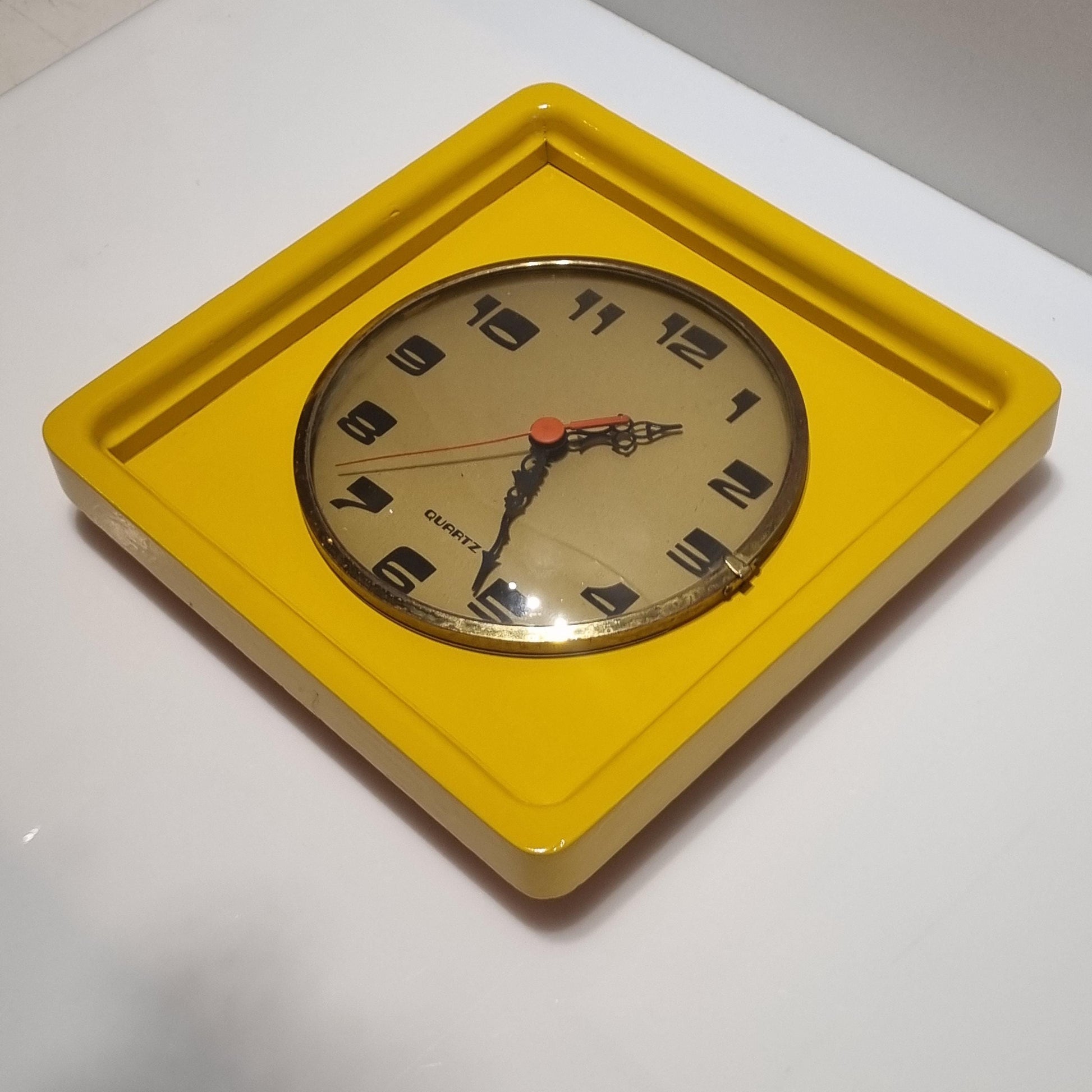 Vintage wood frame wall clock from the 60' after restoration in yellow colored