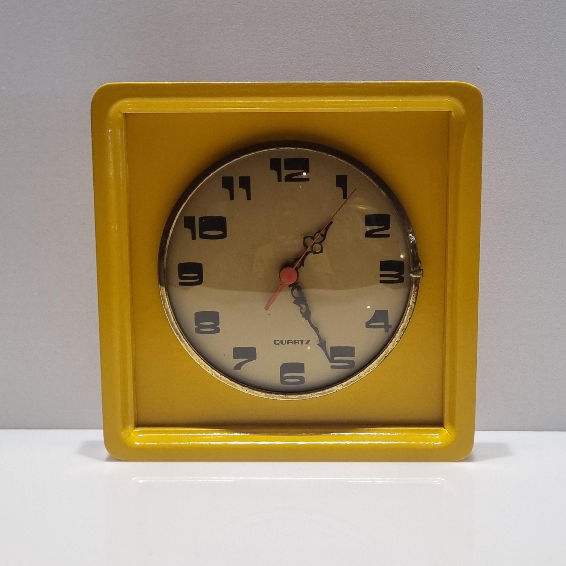 Vintage wood frame wall clock from the 60' after restoration in yellow colored