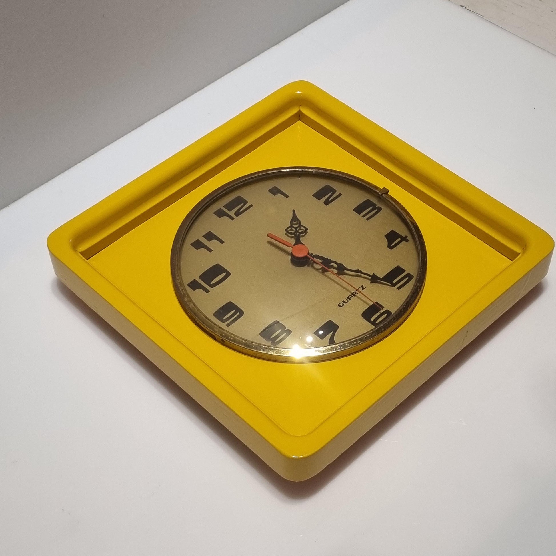 Vintage wood frame wall clock from the 60' after restoration in yellow colored