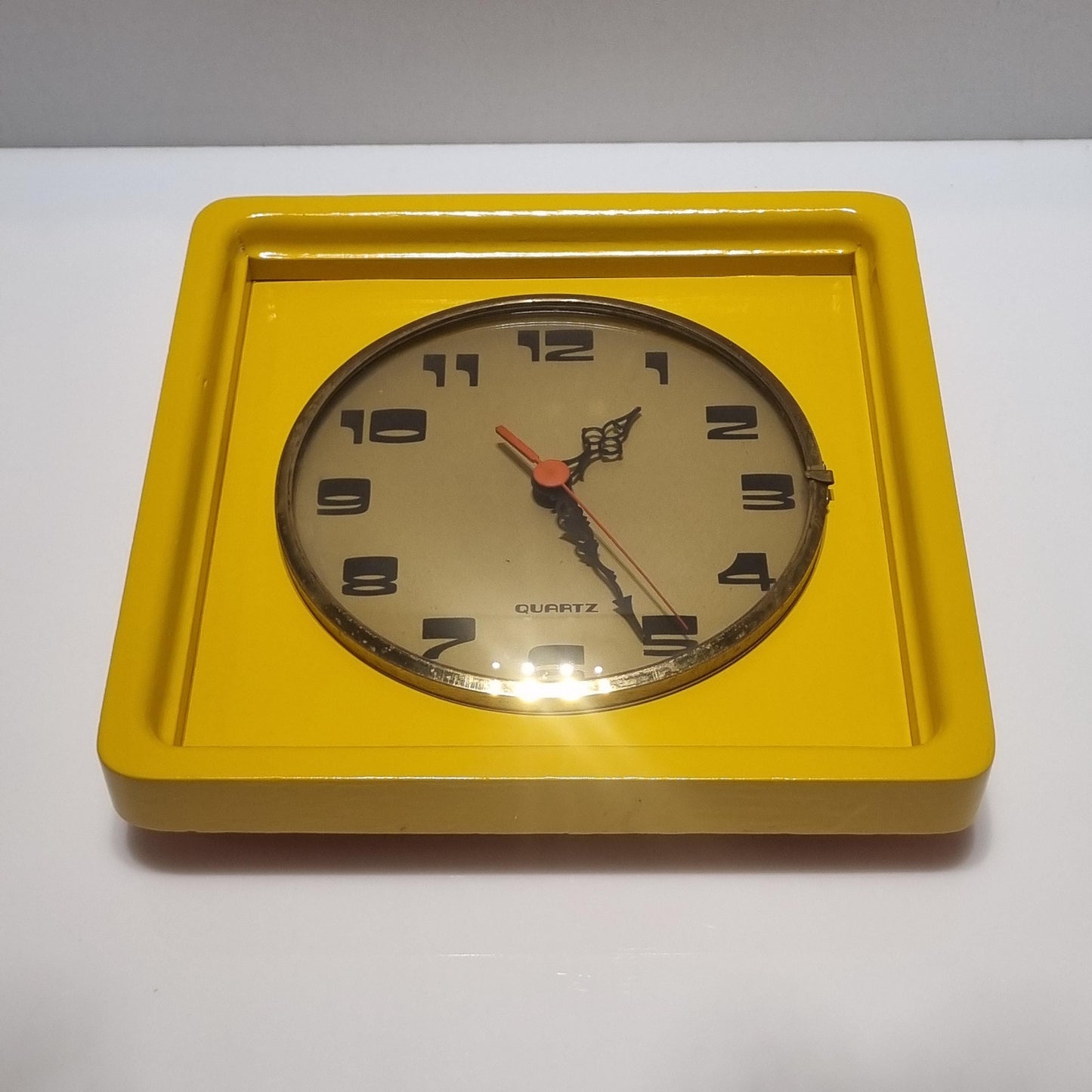 Vintage wood frame wall clock from the 60' after restoration in yellow colored