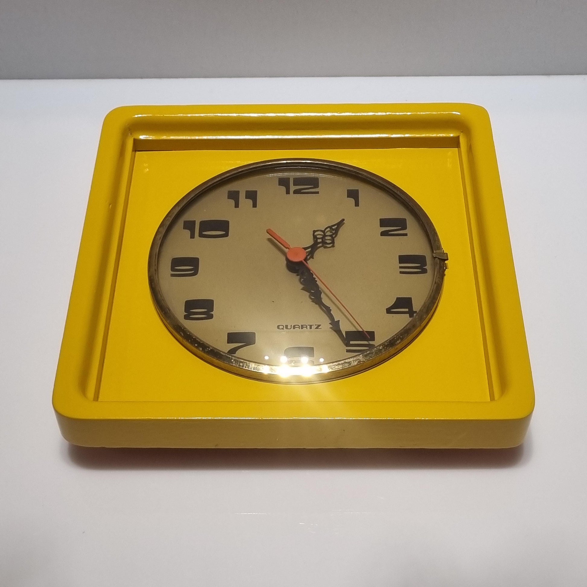 Vintage wood frame wall clock from the 60' after restoration in yellow colored
