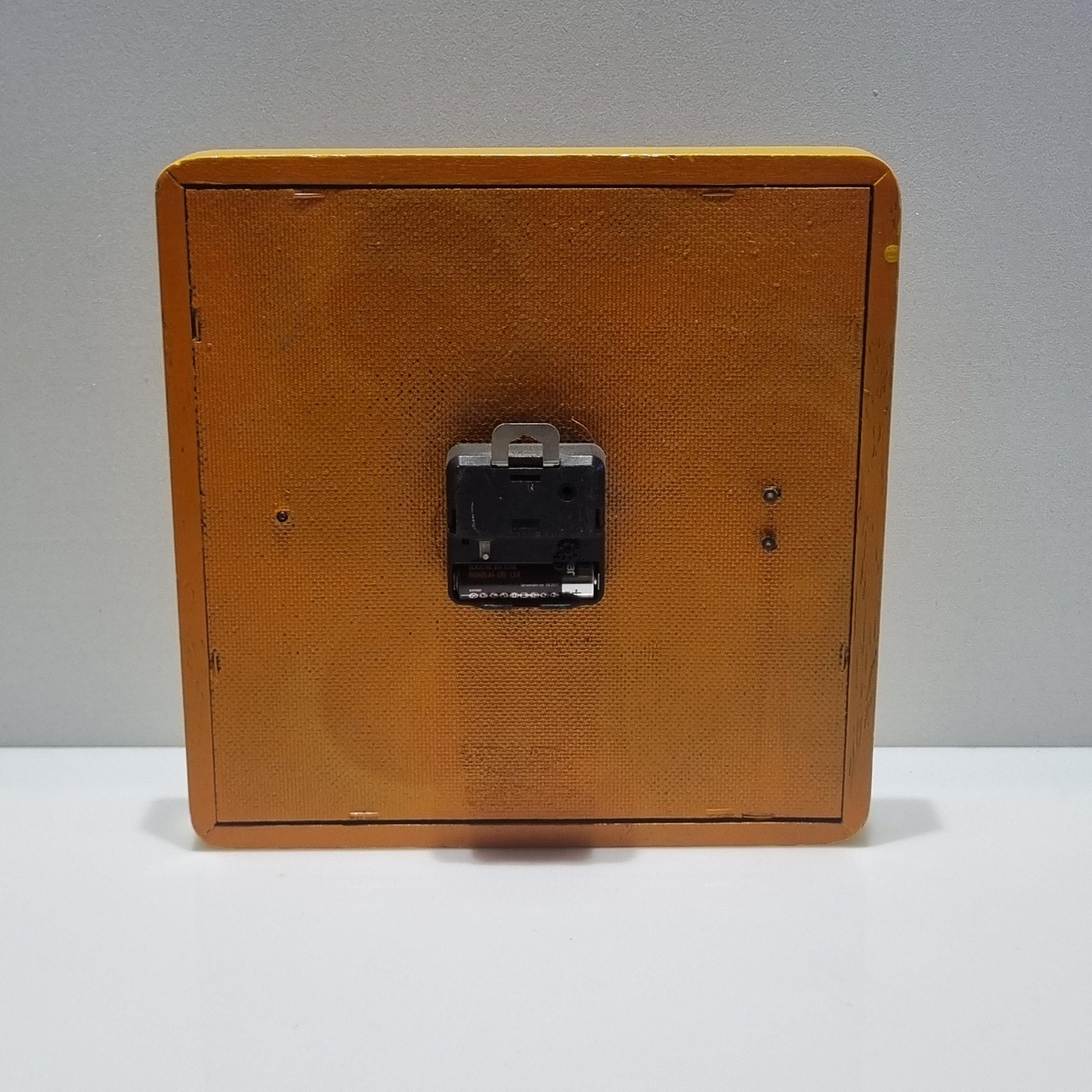 Vintage wood frame wall clock from the 60' after restoration in yellow colored