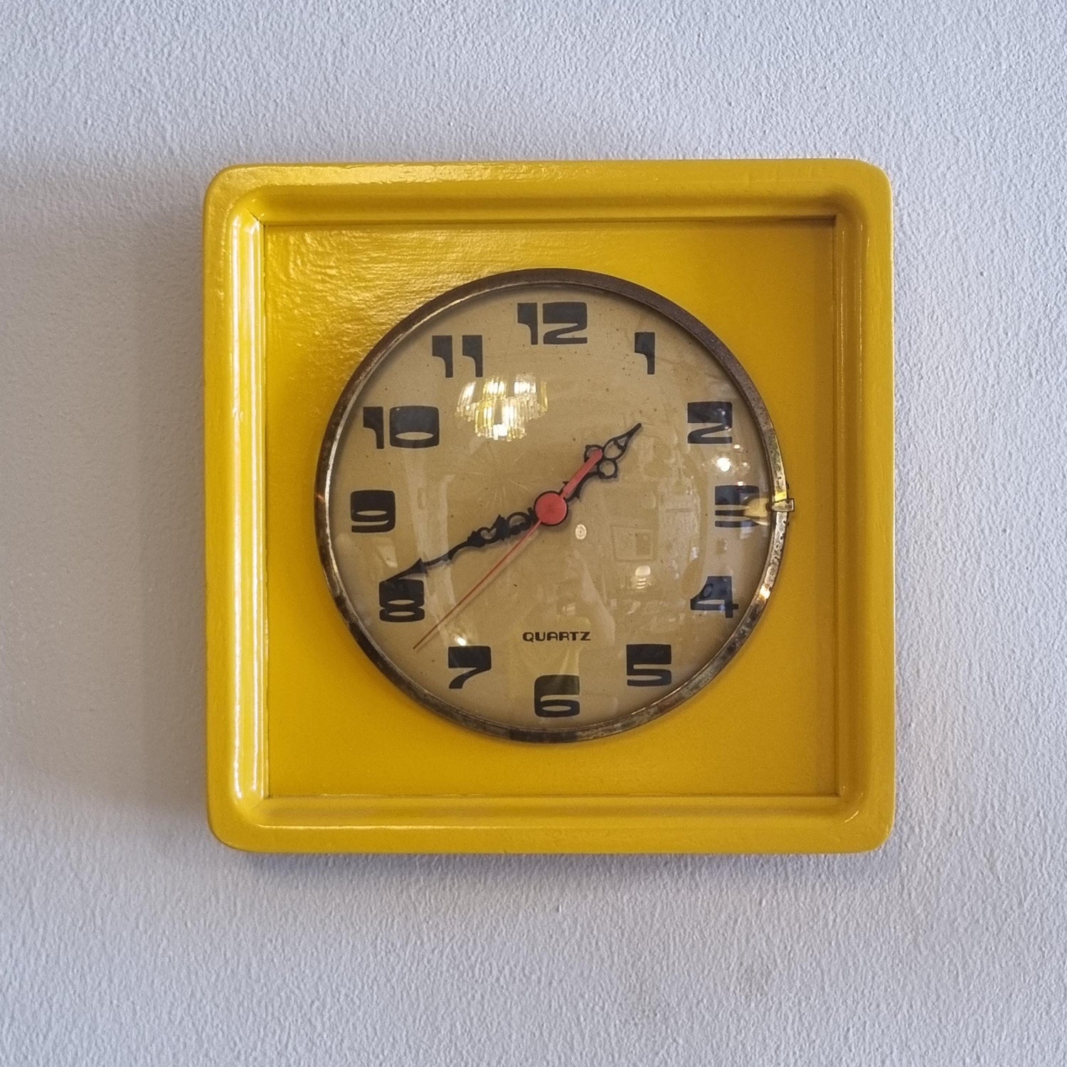 Vintage wood frame wall clock from the 60' after restoration in yellow colored